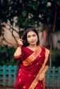Beautiful portrait of a woman in traditional Bengali saree, capturing elegance and cultural richness.